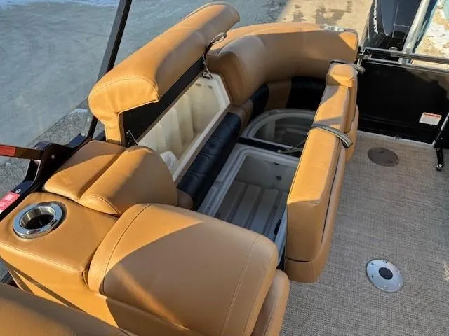 Slide: The Image of 2024 Regency 250 LE3 boat interior with tan seating and storage compartments. - 27