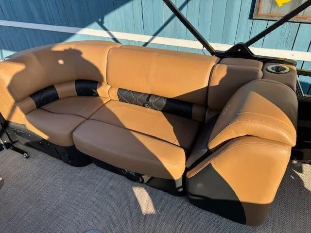 Slide: The Image of 2024 Regency 250 LE3 boat interior with tan leather seating and cup holder. - 28