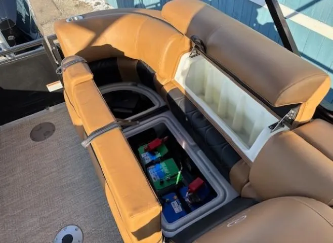 Slide: The Image of 2024 Regency 250 LE3 boat seat storage with battery compartment, tan upholstery. - 29