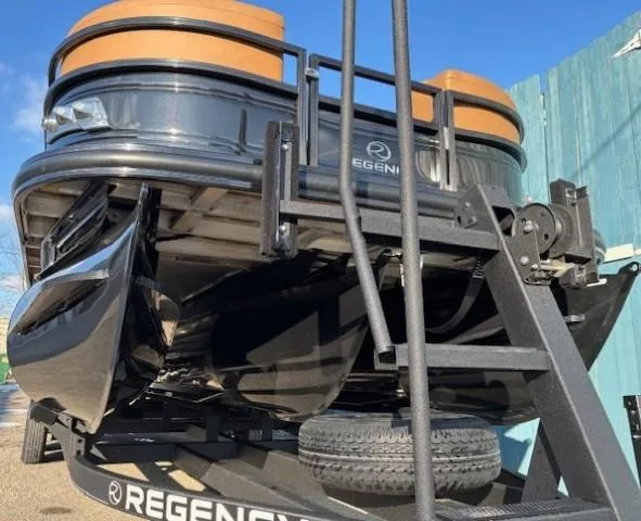 Slide: The Image of 2024 Regency 250 LE3 pontoon boat on trailer, showcasing sleek design and sturdy construction. - 3