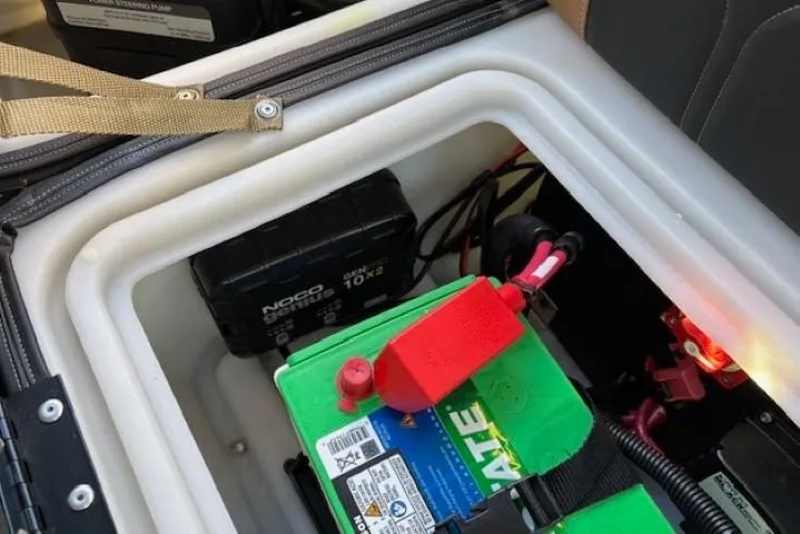Slide: The Image of Battery compartment of 2024 Regency 250 LE3 boat with visible wiring and components. - 30