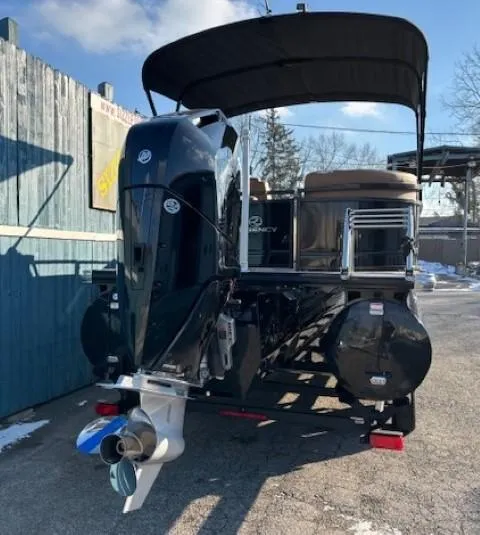 Slide: The Image of 2024 Regency 250 LE3 pontoon boat with canopy, parked outdoors. - 5