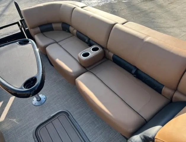 Slide: The Image of 2024 Regency 250 LE3 boat interior with tan seating and cup holders. - 9