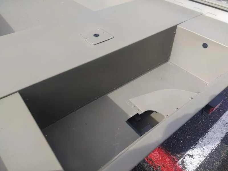 Slide: The Image of 2025 Tracker Grizzly 1754 Jon boat interior, showcasing storage compartment and seating area. - 10