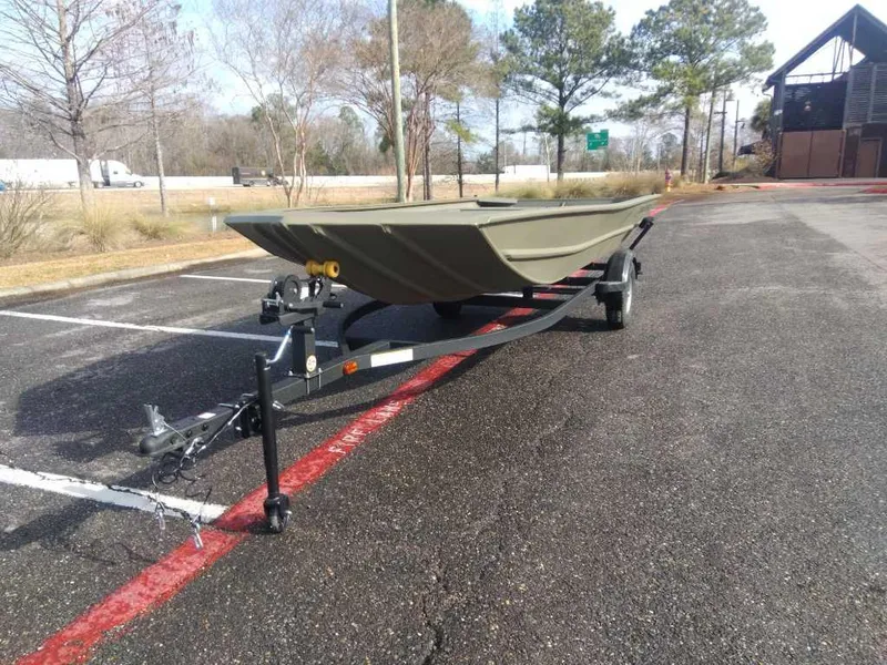 Slide: The Image of 2025 Tracker Grizzly 1754 Jon boat on trailer in parking lot. - 12