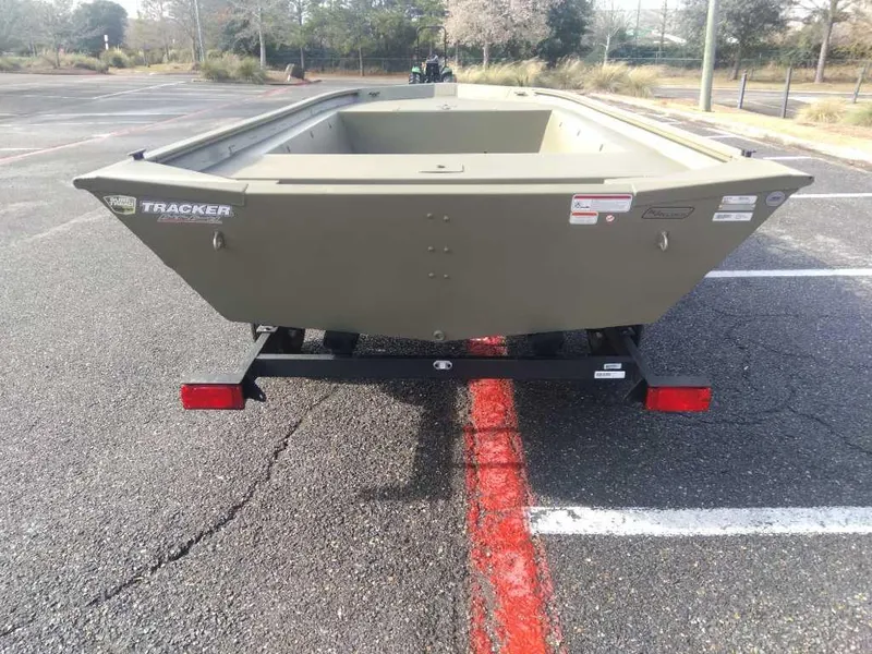 Slide: The Image of 2025 Tracker Grizzly 1754 Jon boat on trailer in parking lot. - 2