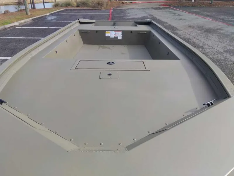 Slide: The Image of 2025 Tracker Grizzly 1754 Jon boat, empty interior view, parked outdoors. - 7