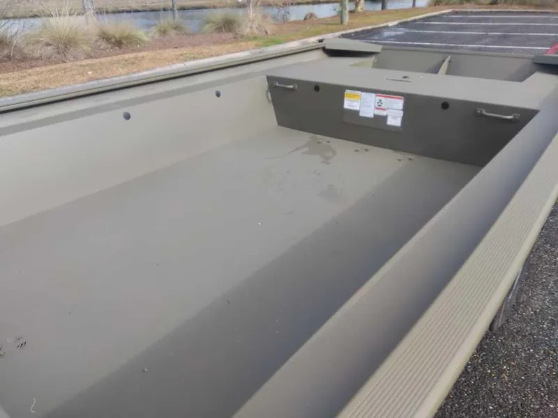 Slide: The Image of 2025 Tracker Grizzly 1754 Jon boat, empty interior view, parked outdoors. - 9