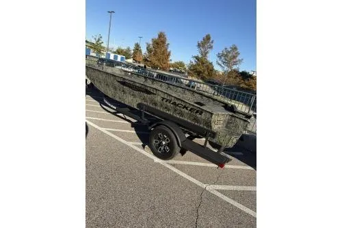 The Image of 2025 Tracker Grizzly 1650 T Prairie Wings Edition boat on trailer in parking lot. - 0