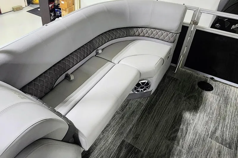 Slide: The Image of Luxurious seating in 2025 Ranger Reata 243C boat with quilted upholstery and integrated speaker. - 14