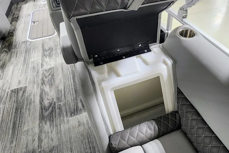 Slide: The Image of 2025 Ranger Reata 243C interior with open storage compartment and stylish seating. - 15