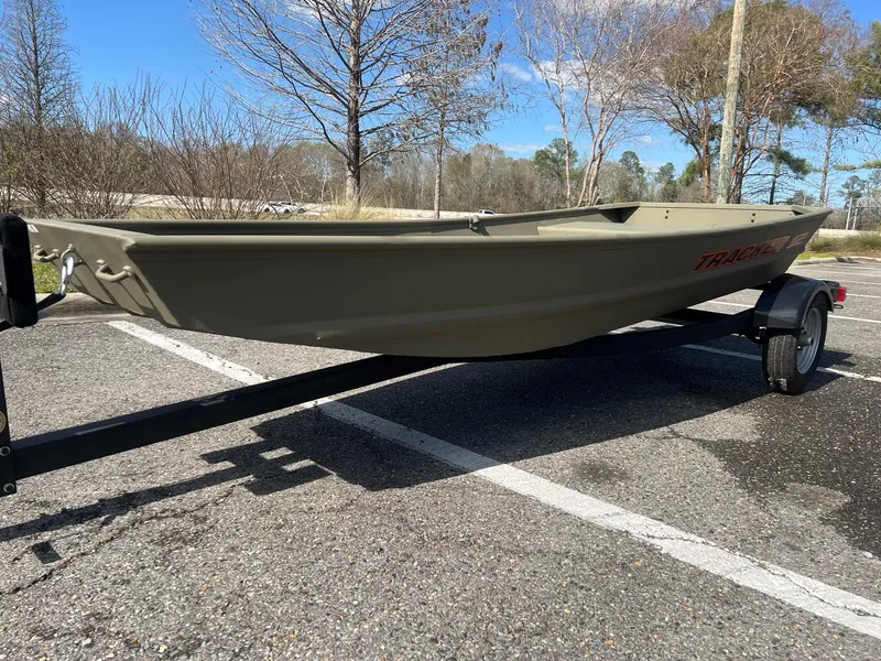 Slide: The Image of 2025 Tracker Grizzly 1236 Utility boat on trailer in parking lot. - 3