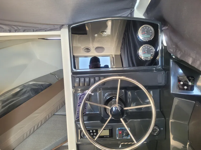 Slide: The Image of 2025 Bayliner Trophy T23 Explorer helm with steering wheel and gauges. - 10