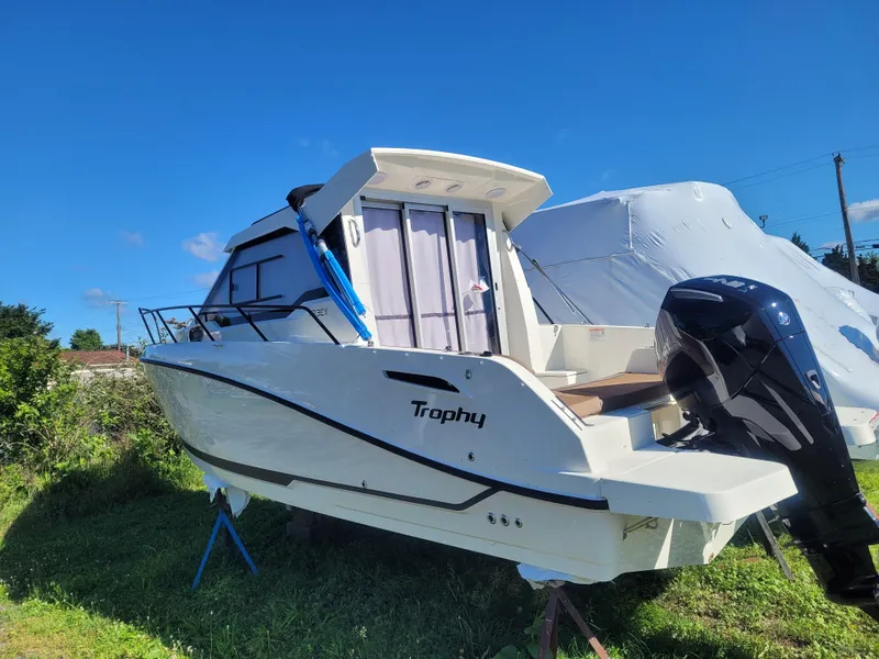 Slide: The Image of 2025 Bayliner Trophy T23 Explorer boat on grass, clear sky background. - 4