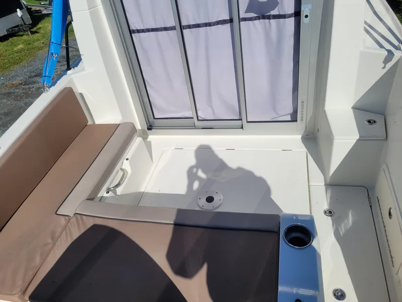 Slide: The Image of 2025 Bayliner Trophy T23 Explorer boat interior with seating and cup holder. - 6