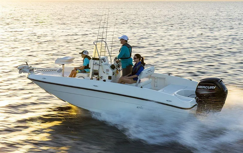 Slide: The Image of 2025 Bayliner T18 Limited Edition boat cruising on open water at sunset. - 1