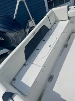 Slide: The Image of 2025 Tidewater 232 LXF boat interior with seating and storage compartments. - 10