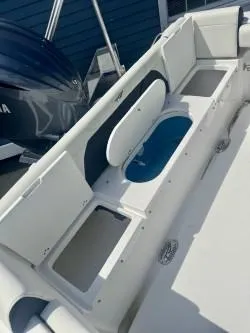 Slide: The Image of 2025 Tidewater 232 LXF boat interior with storage compartments and seating. - 11