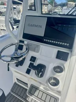 Slide: The Image of 2025 Tidewater 232 LXF boat console with Garmin display and steering wheel. - 14