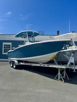 Slide: The Image of 2025 Tidewater 232 LXF boat on trailer, blue hull, parked outdoors. - 4