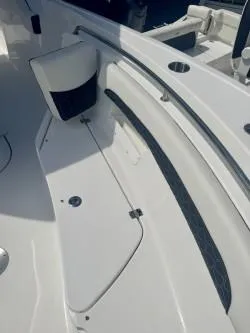 Slide: The Image of 2025 Tidewater 232 LXF boat interior, featuring sleek white seating and modern design elements. - 9