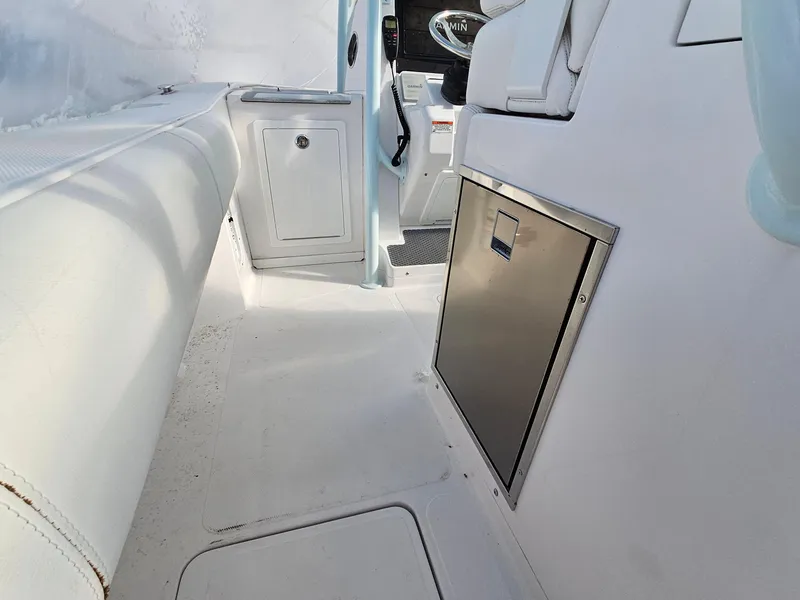Slide: The Image of Interior view of 2017 Southport 33 LX boat, featuring seating and storage compartments. - 10