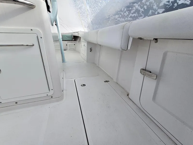 Slide: The Image of 2017 Southport 33 LX boat interior with white seating and storage compartments. - 11