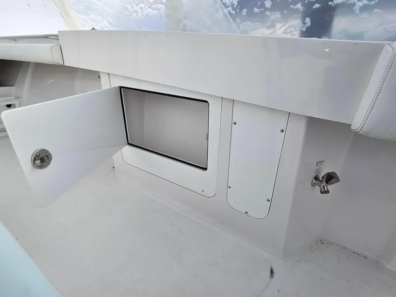 Slide: The Image of Open storage compartment on a 2017 Southport 33 LX boat interior. - 13
