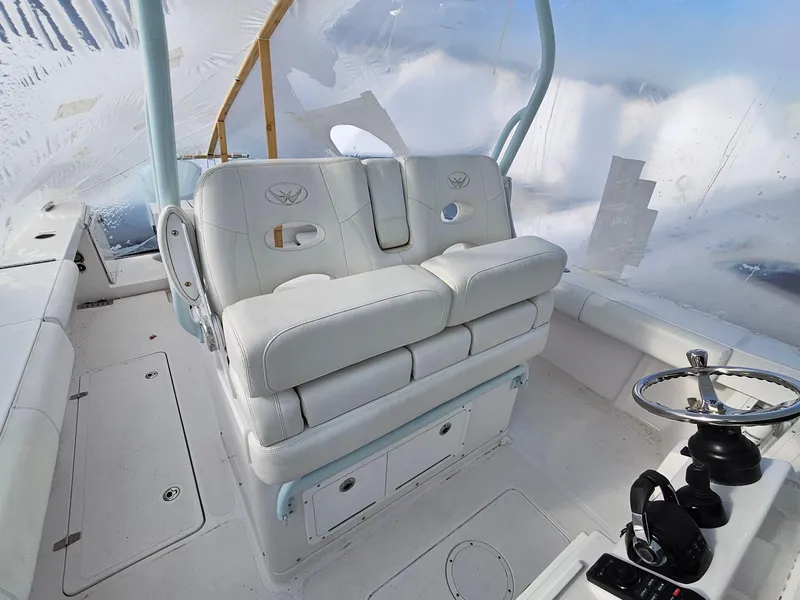 Slide: The Image of 2017 Southport 33 LX boat interior with white seating and steering wheel. - 14