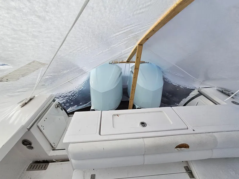 Slide: The Image of 2017 Southport 33 LX boat under cover, showcasing dual engines. - 4