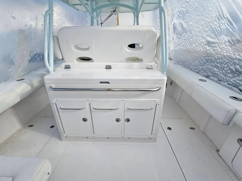 Slide: The Image of 2017 Southport 33 LX boat interior with white seating and storage compartments. - 6