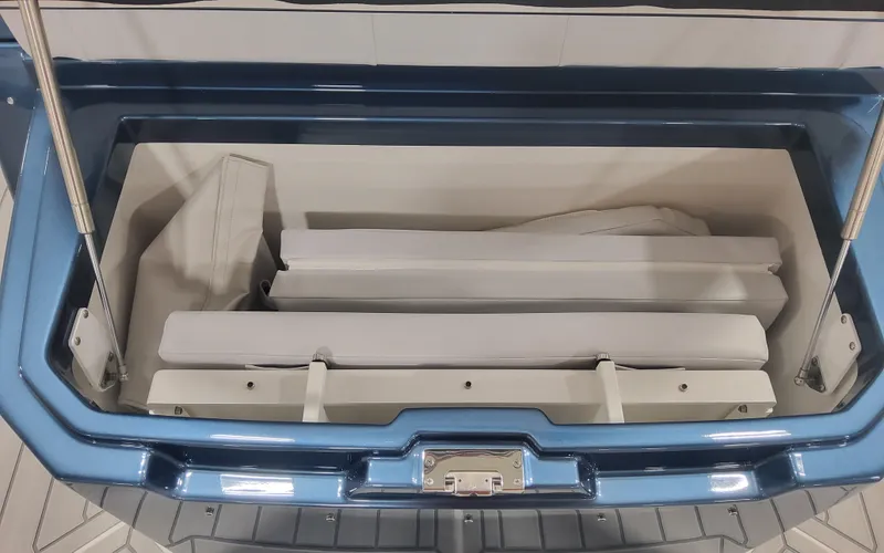 Slide: The Image of 2025 Formula 387 Center Console Fish storage compartment, open with white interior and blue exterior. - 11