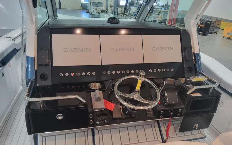Slide: The Image of 2025 Formula 387 Center Console Fish dashboard with Garmin displays and steering wheel. - 13