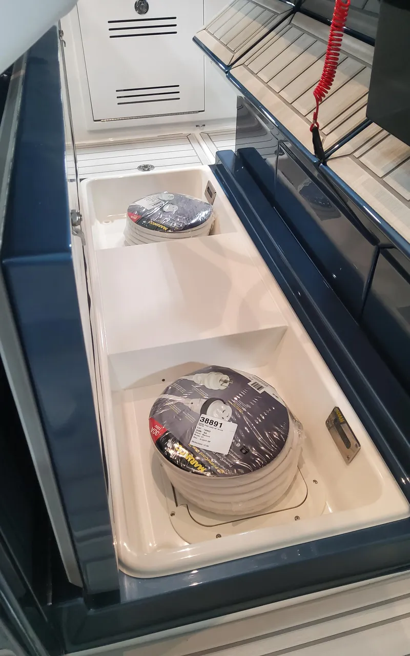 Slide: The Image of 2025 Formula 387 Center Console Fish boat storage compartments with coiled ropes. - 19