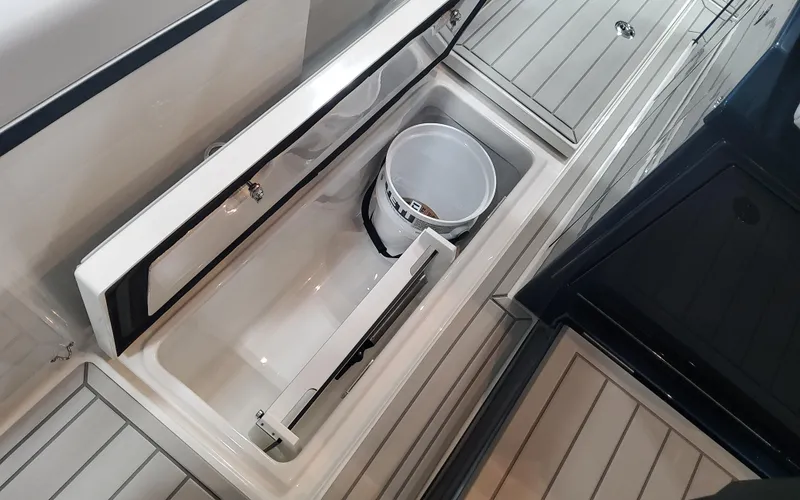 Slide: The Image of 2025 Formula 387 Center Console Fish boat storage compartment with bucket. - 22