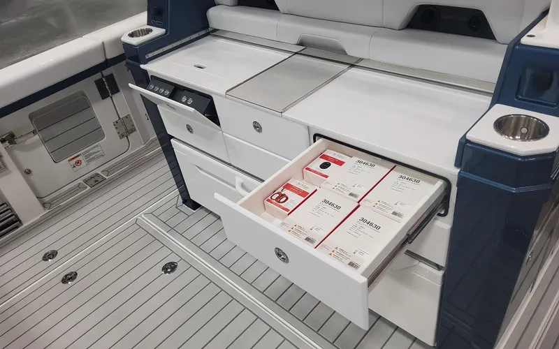 Slide: The Image of 2025 Formula 387 Center Console Fish boat with open storage drawer on deck. - 25