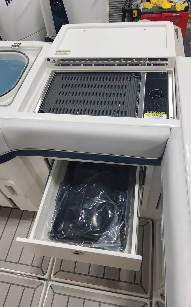 Slide: The Image of 2025 Formula 387 Center Console Fish boat interior with storage and grill. - 28