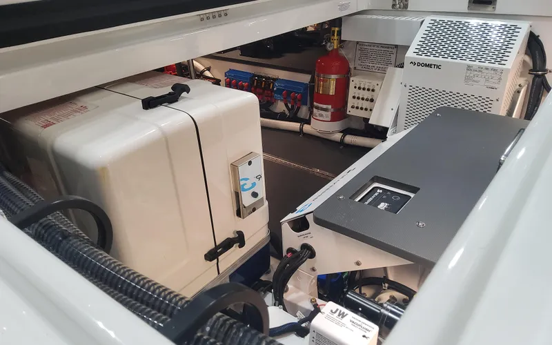 Slide: The Image of 2025 Formula 387 Center Console Fish engine compartment with equipment and fire extinguisher. - 30