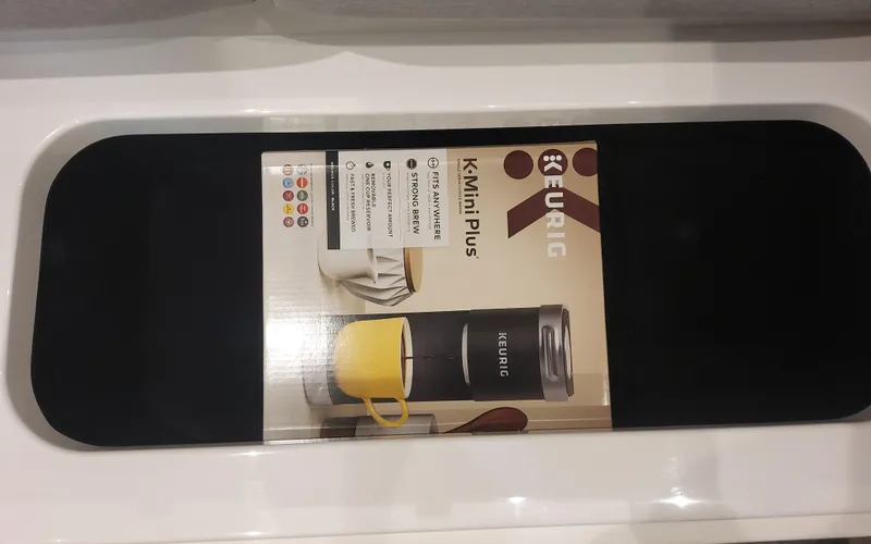 Slide: The Image of Keurig K-Mini Plus coffee maker box on display, featuring a compact design. - 39