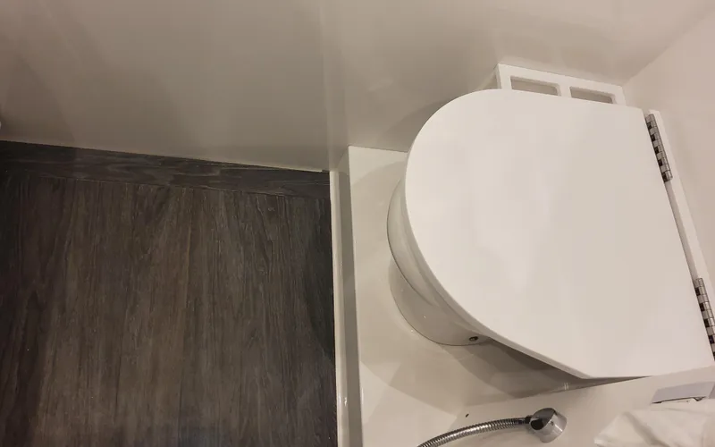 Slide: The Image of 2025 Formula 387 Center Console Fish boat bathroom with modern toilet and sleek flooring. - 41