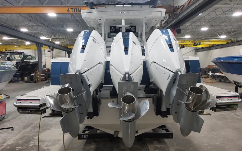 Slide: The Image of 2025 Formula 387 Center Console Fish boat with triple outboard engines in a workshop. - 45