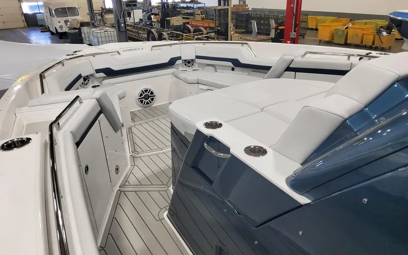 Slide: The Image of 2025 Formula 387 Center Console Fish boat interior with seating and cup holders. - 5