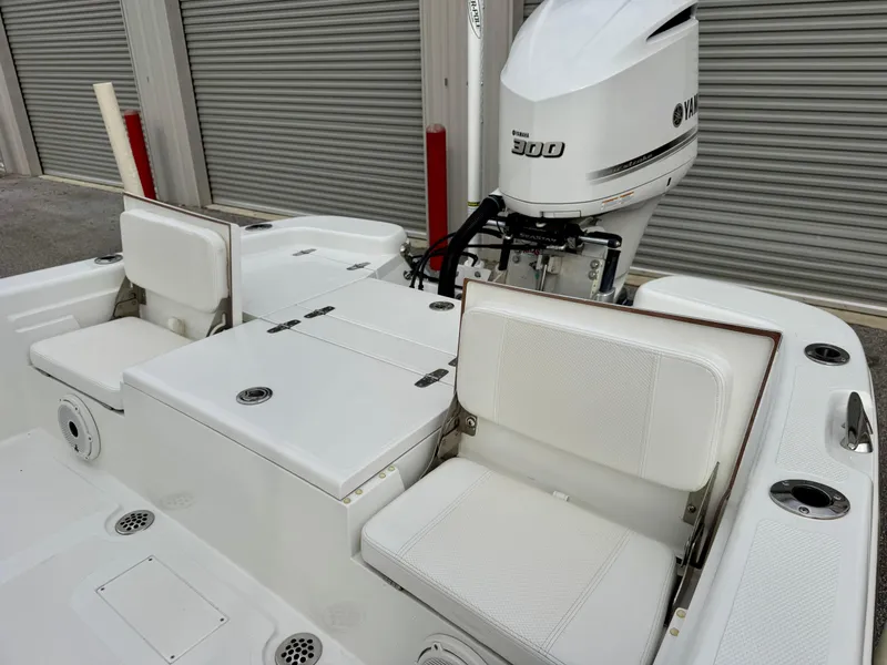 Slide: The Image of 2020 BlackJack 256 Bay boat with Yamaha 300 engine, featuring white seating and storage compartments. - 10