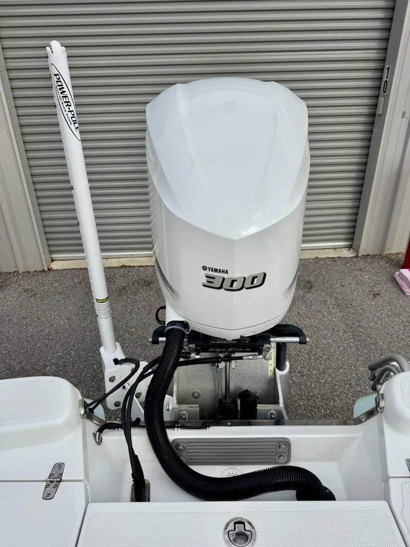 Slide: The Image of 2020 BlackJack 256 Bay boat with Yamaha 300 outboard motor, parked near a garage door. - 11