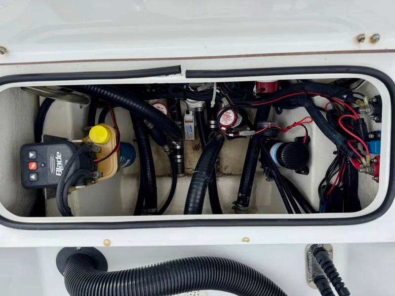 Slide: The Image of 2020 BlackJack 256 Bay boat wiring and components inside a compartment. - 12