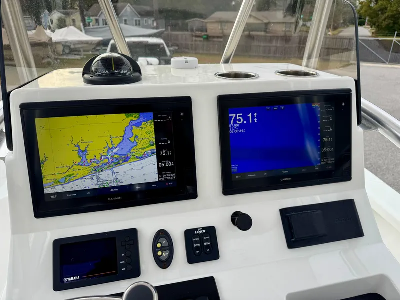 Slide: The Image of 2020 BlackJack 256 Bay boat dashboard with navigation screens and controls. - 15