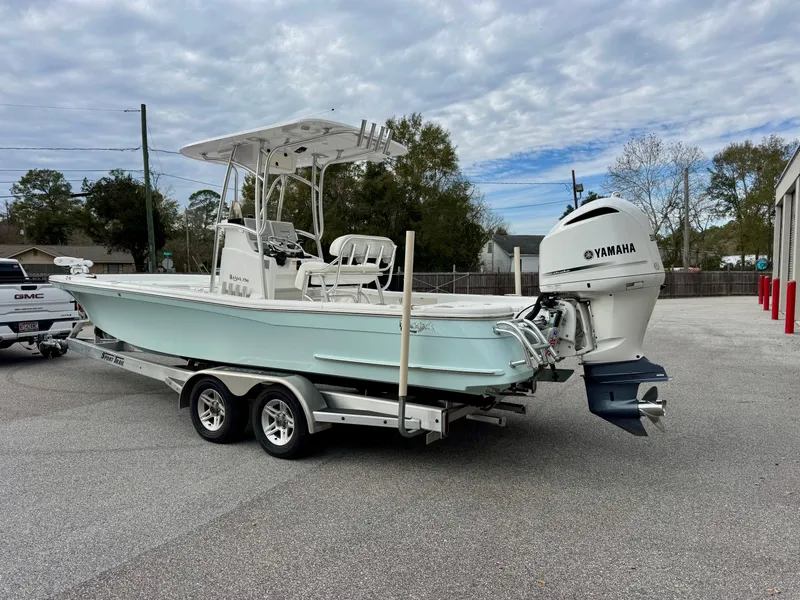 Slide: The Image of 2020 BlackJack 256 Bay boat on trailer with Yamaha outboard motor, parked outdoors. - 3