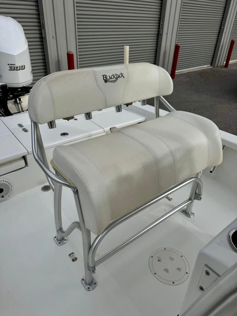 Slide: The Image of 2020 BlackJack 256 Bay boat seat with white upholstery and metal frame. - 8
