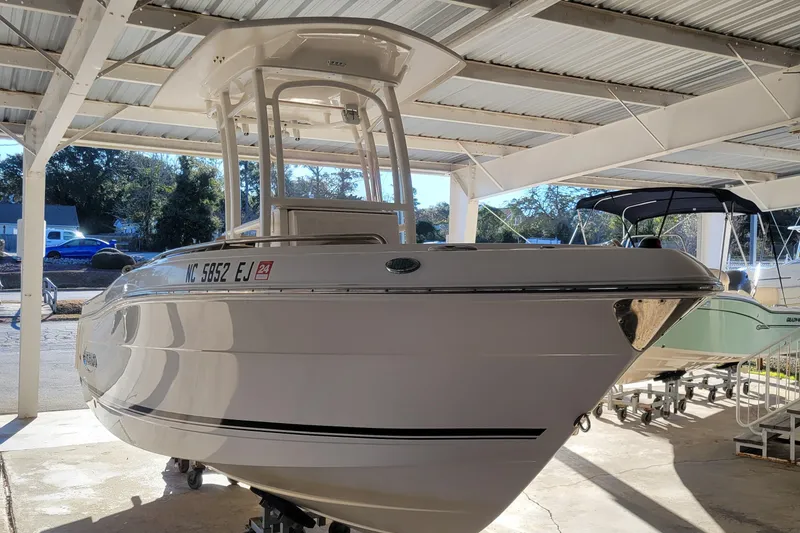 Slide: The Image of 2018 Robalo R222 Center Console boat in covered storage area. - 2