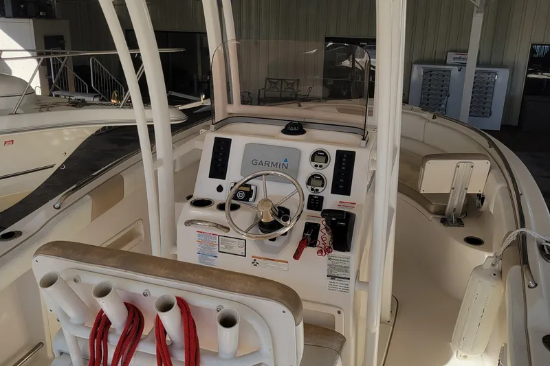 Slide: The Image of 2018 Robalo R222 Center Console boat interior with Garmin navigation system and rod holders. - 4